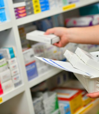 Pharmacist filling prescription in pharmacy drugstore